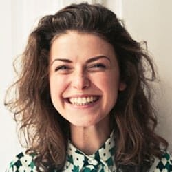 A woman with long hair and a green shirt.